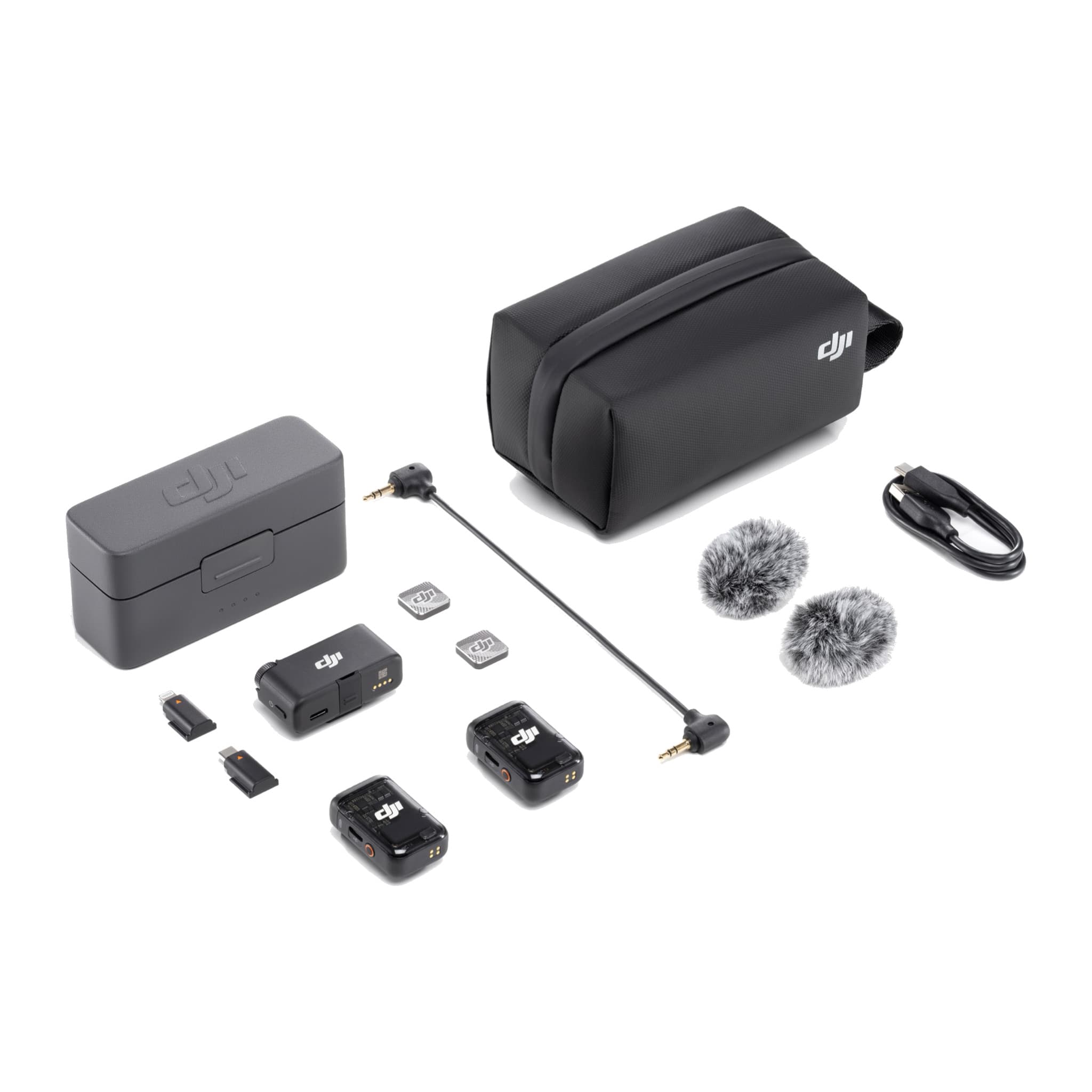 DJI Mic 2 kit laid out: charging case, two transmitters, receiver, adapters, cable, windscreens and bag