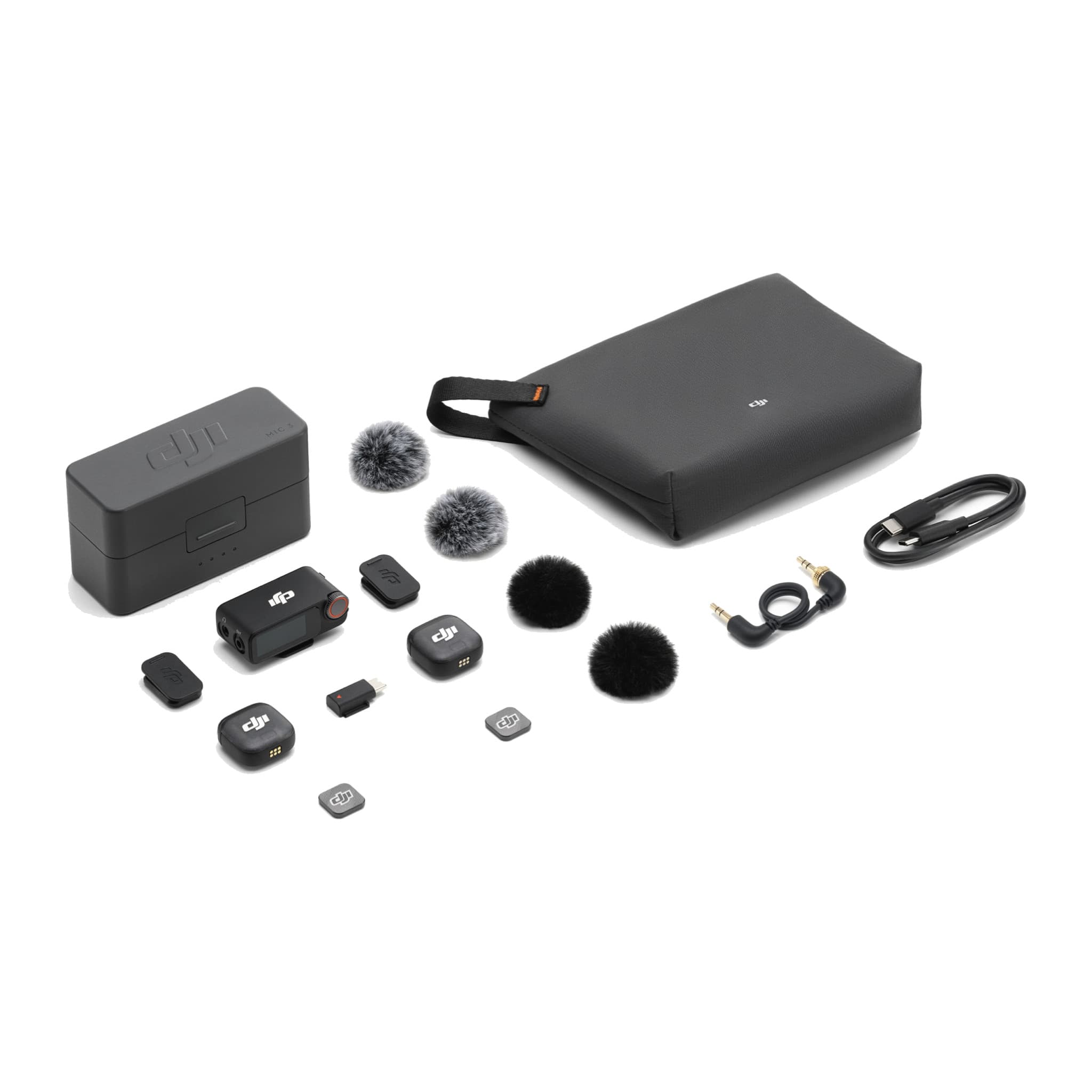 DJI Mic 3 kit laid out: charging case, two transmitters, receiver, magnets, windscreens, cables and pouch